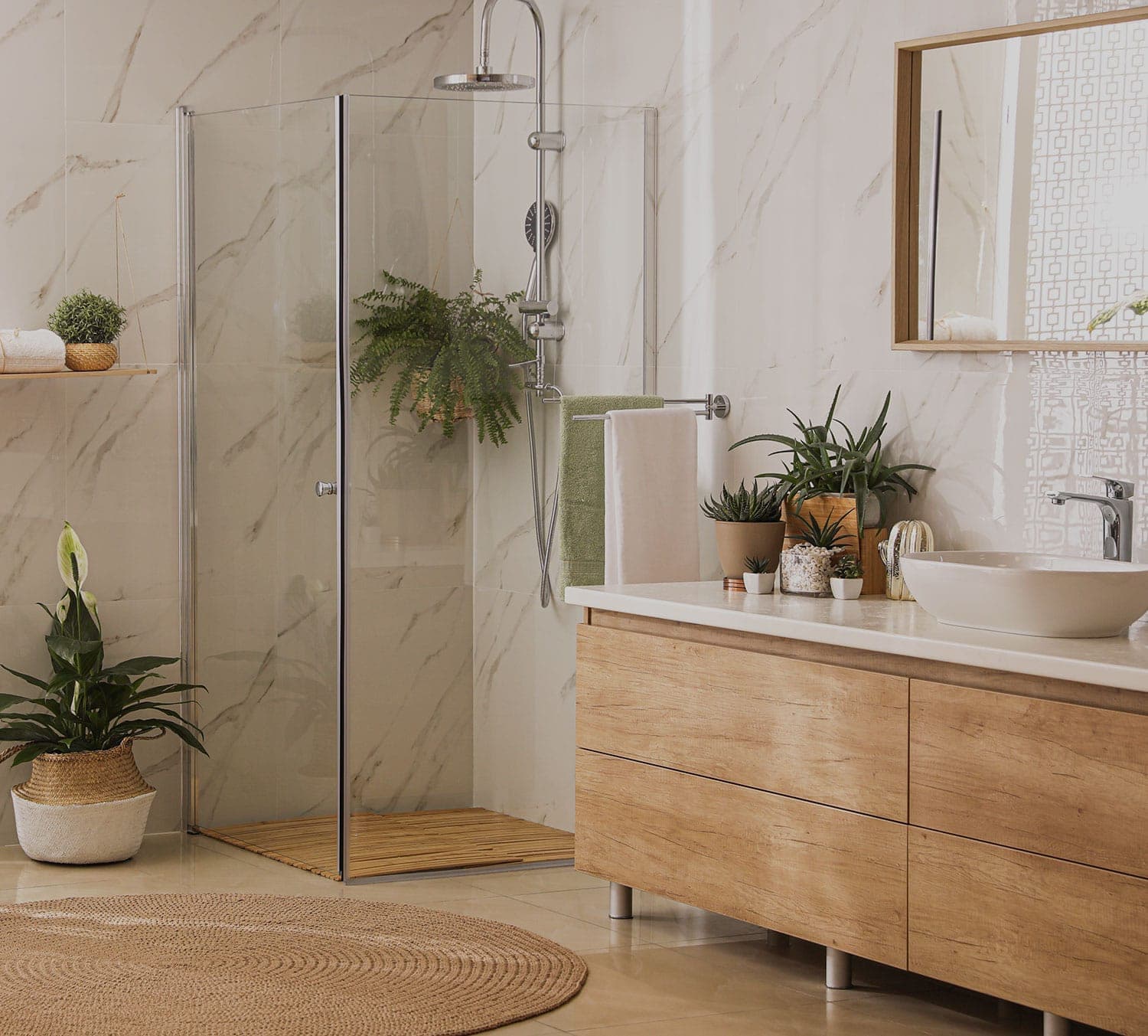 Renovated bathroom with a glass shower, marble tiling and a timber vanity