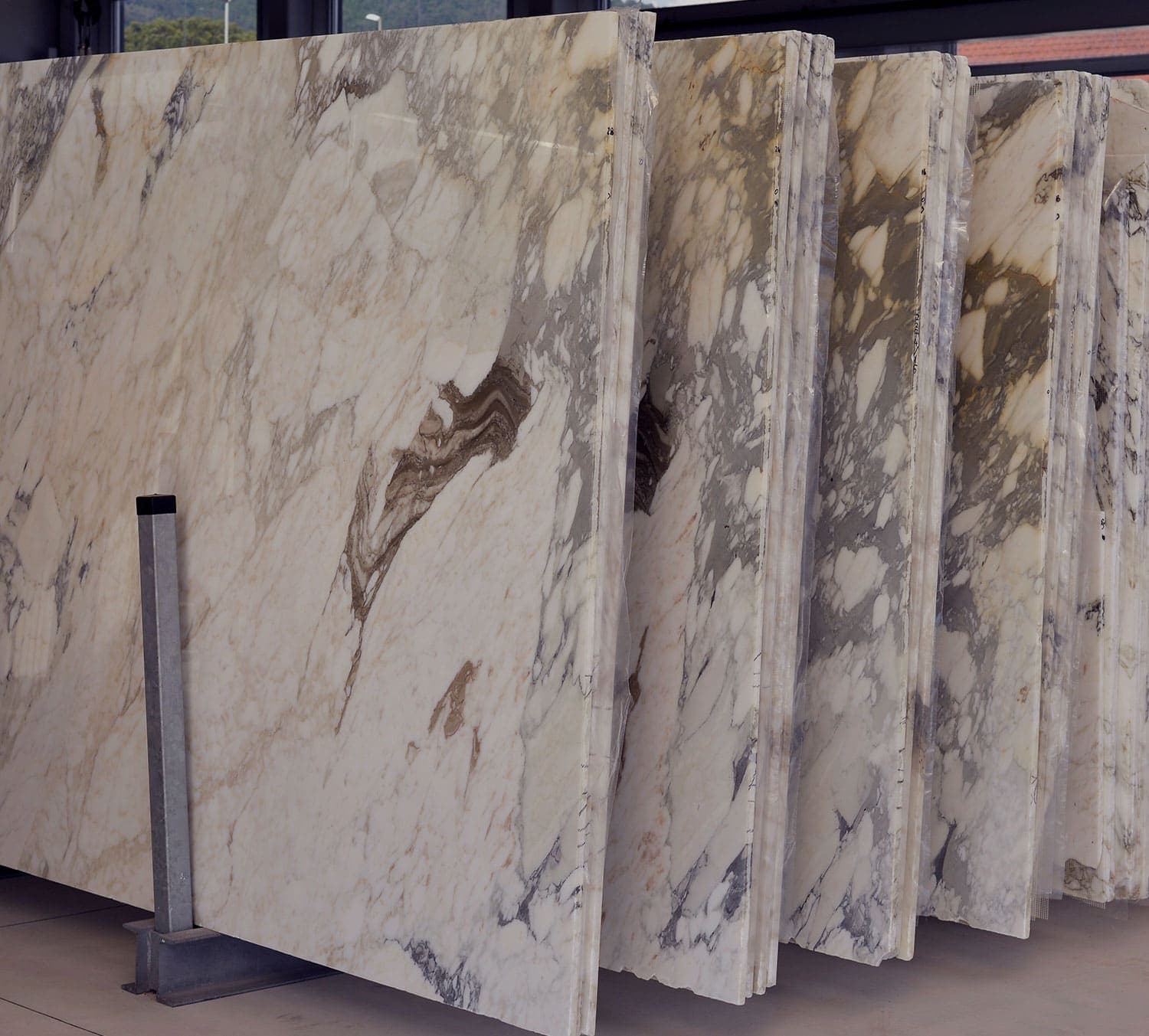 Marble slabs standing on end in a stone yard, ready to be cut for benchtops